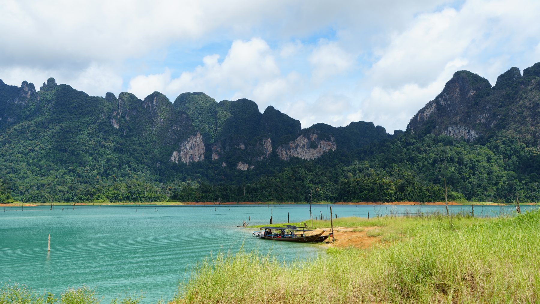 Emerald water and limestone peaks on Cheow Lan Lake, the tops of hills that stood in the valley before the dam